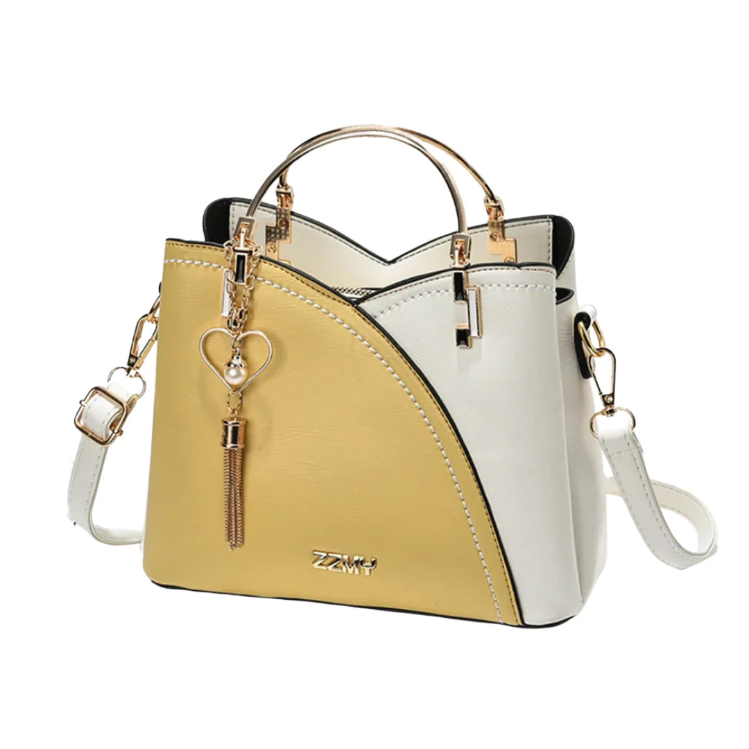 Ivory and taupe two-tone faux leather tote bag with gold-tone hardware, dual top handles, detachable crossbody strap, and heart-shaped charm with pearl accent.