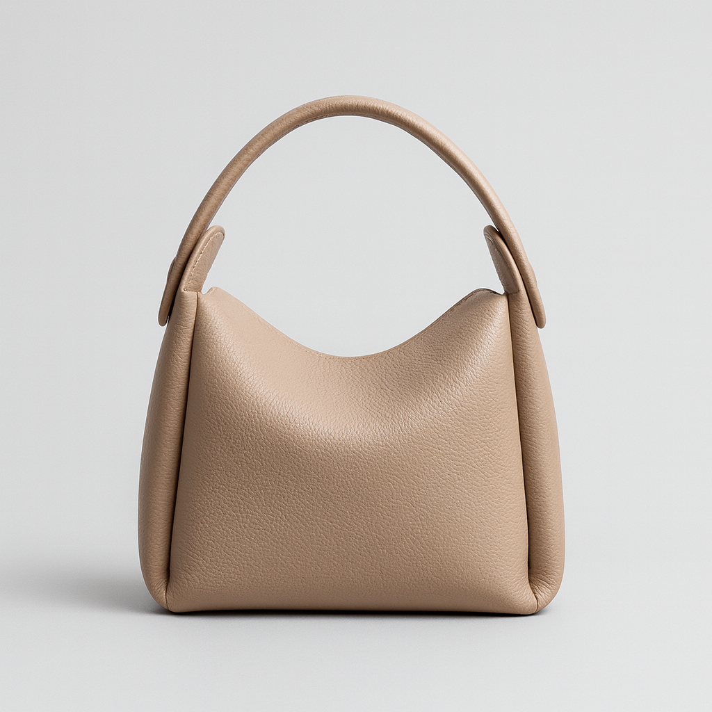 Soft curve shoulder bag with smooth leather finish, rounded silhouette, adjustable strap, and minimalist design for everyday wear