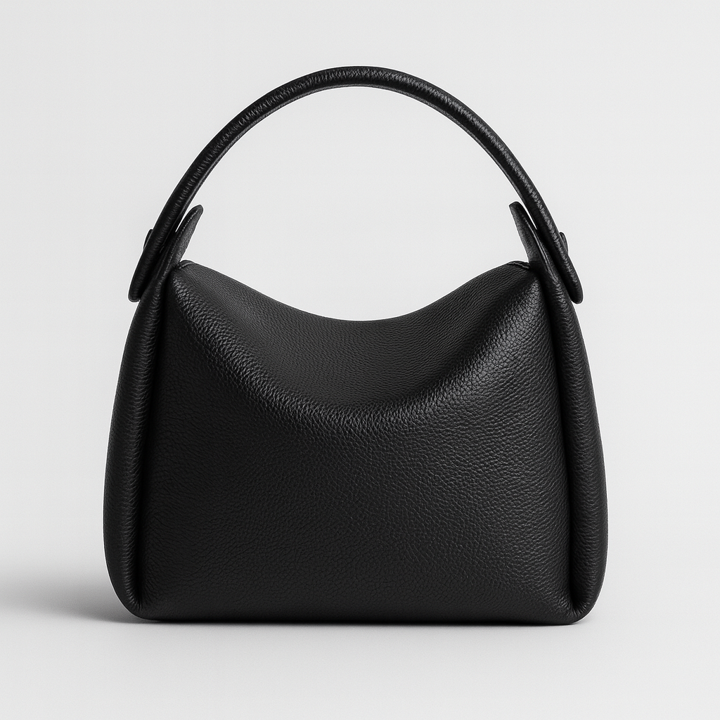 Soft curve shoulder bag with smooth leather finish, rounded silhouette, adjustable strap, and minimalist design for everyday wear