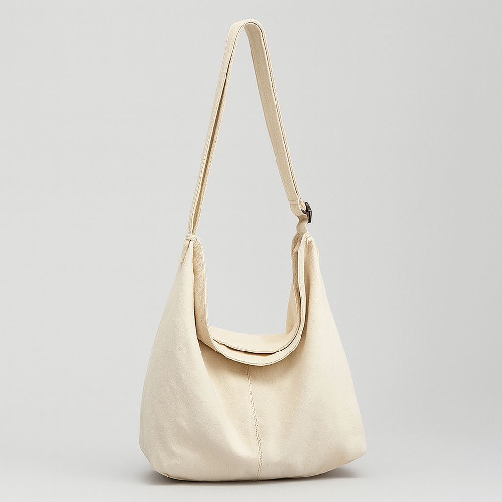 Canvas shoulder bag with oversized silhouette, soft shoulder strap, and spacious interior.