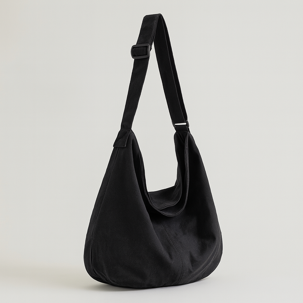 Canvas shoulder bag with oversized silhouette, soft shoulder strap, and spacious interior.