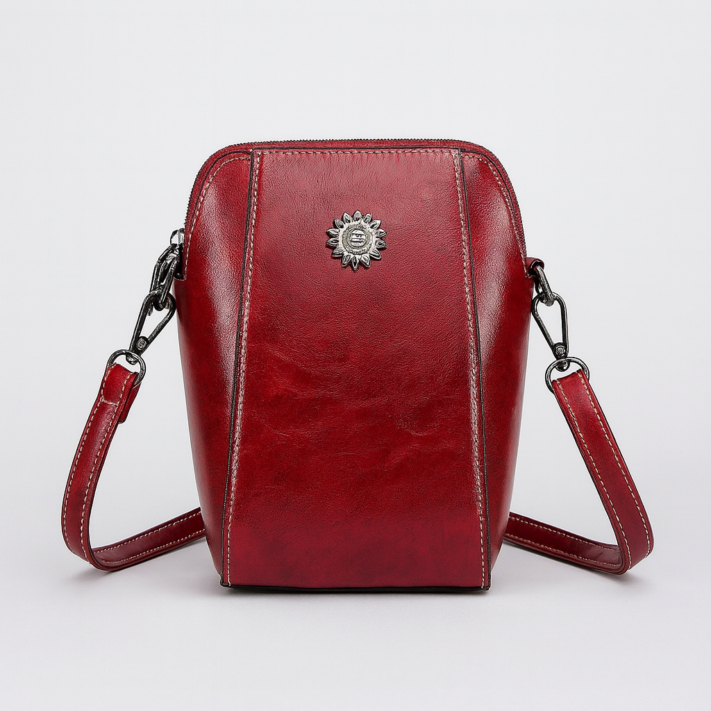 Compact crossbody bag with sleek leather finish, adjustable strap, secure top zip closure, and minimalist design for everyday use