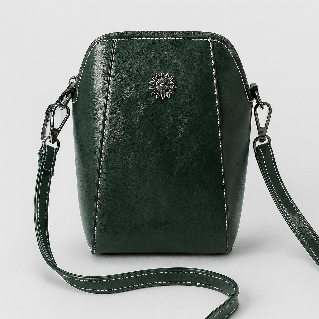 Compact crossbody bag with sleek leather finish, adjustable strap, secure top zip closure, and minimalist design for everyday use