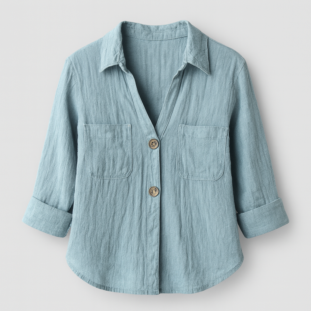Light blue linen button shirt with V-neckline, front pockets, and three-quarter rolled sleeves, styled for a breezy summer look