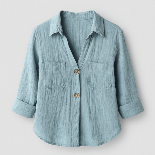 Light blue linen button shirt with V-neckline, front pockets, and three-quarter rolled sleeves, styled for a breezy summer look