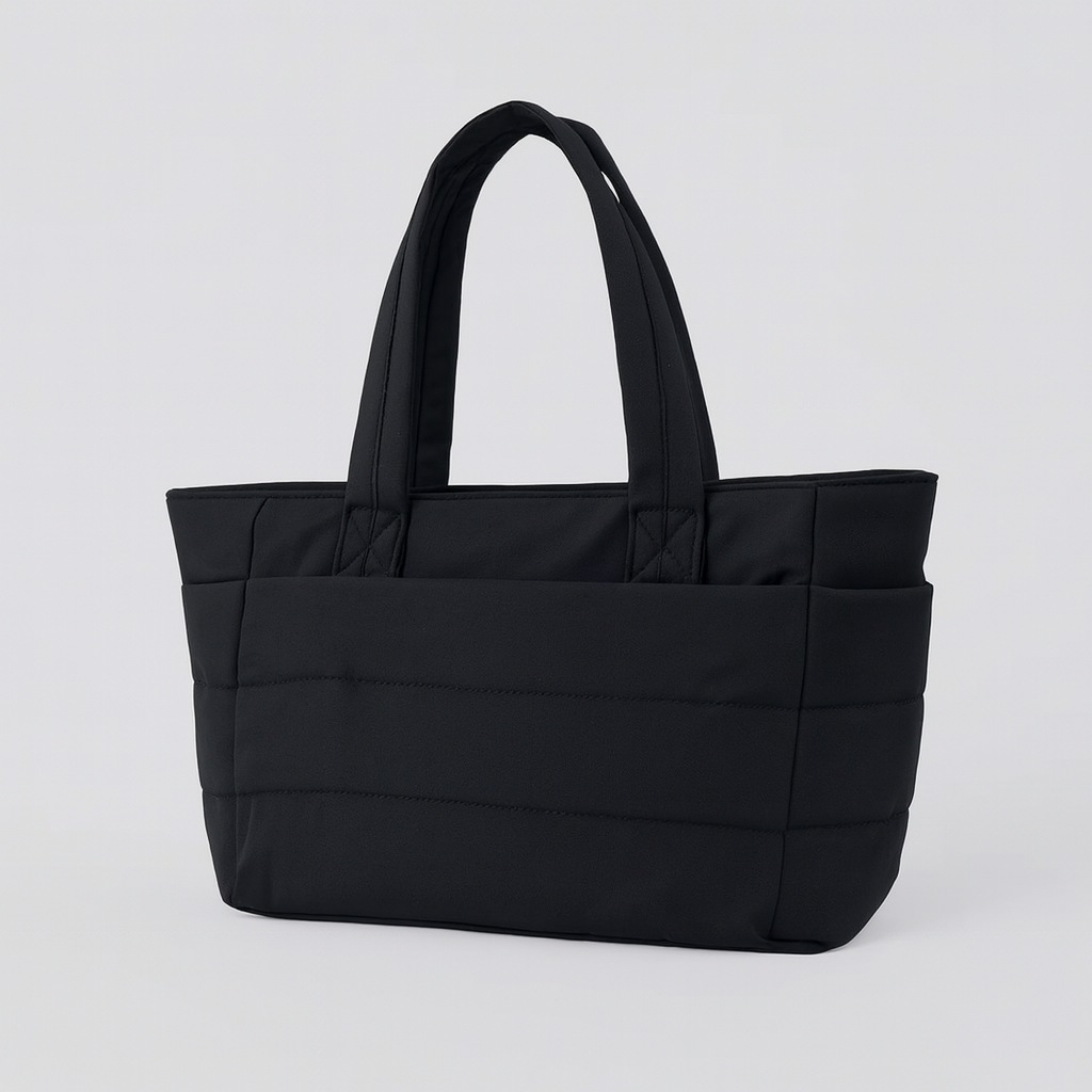 Quilted tote bag with a spacious main compartment, soft padded design, and sturdy shoulder straps for daily use.