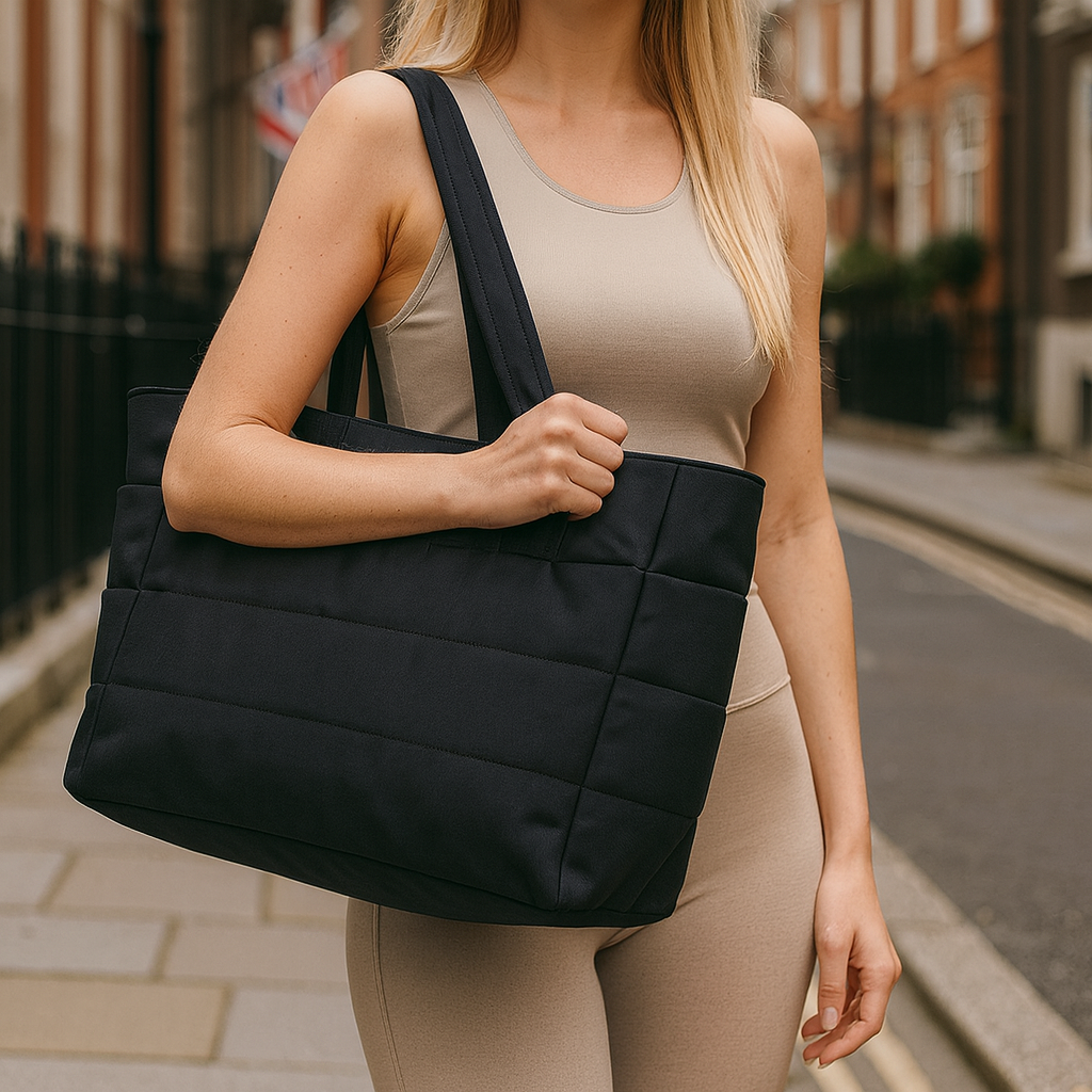 Quilted tote bag with a spacious main compartment, soft padded design, and sturdy shoulder straps for daily use.
