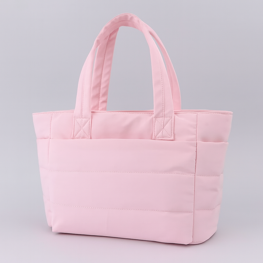 Quilted tote bag with a spacious main compartment, soft padded design, and sturdy shoulder straps for daily use.