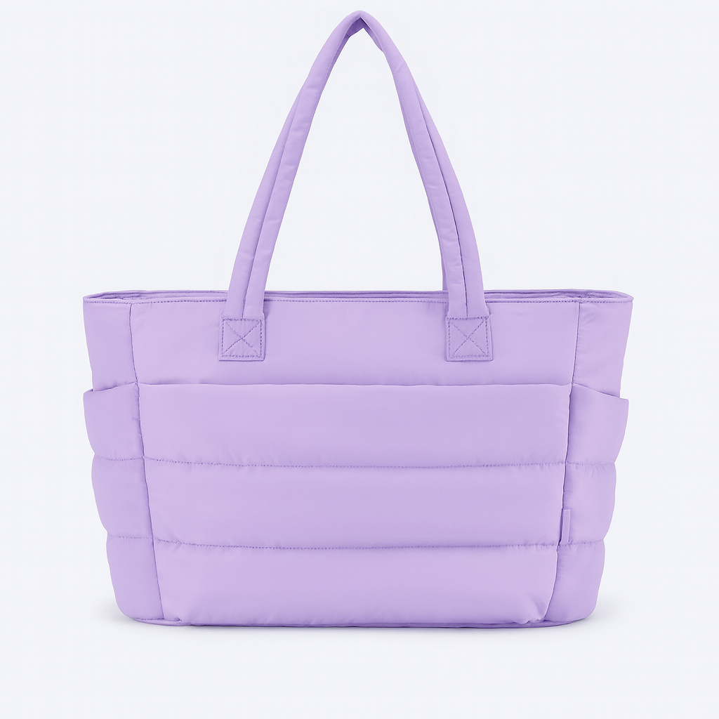 Quilted tote bag with a spacious main compartment, soft padded design, and sturdy shoulder straps for daily use.