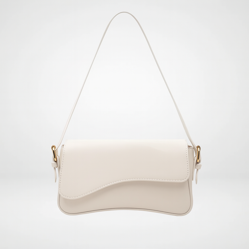 Curved flap shoulder bag with smooth leather finish, adjustable strap, magnetic closure, and sleek minimalist design for everyday wear